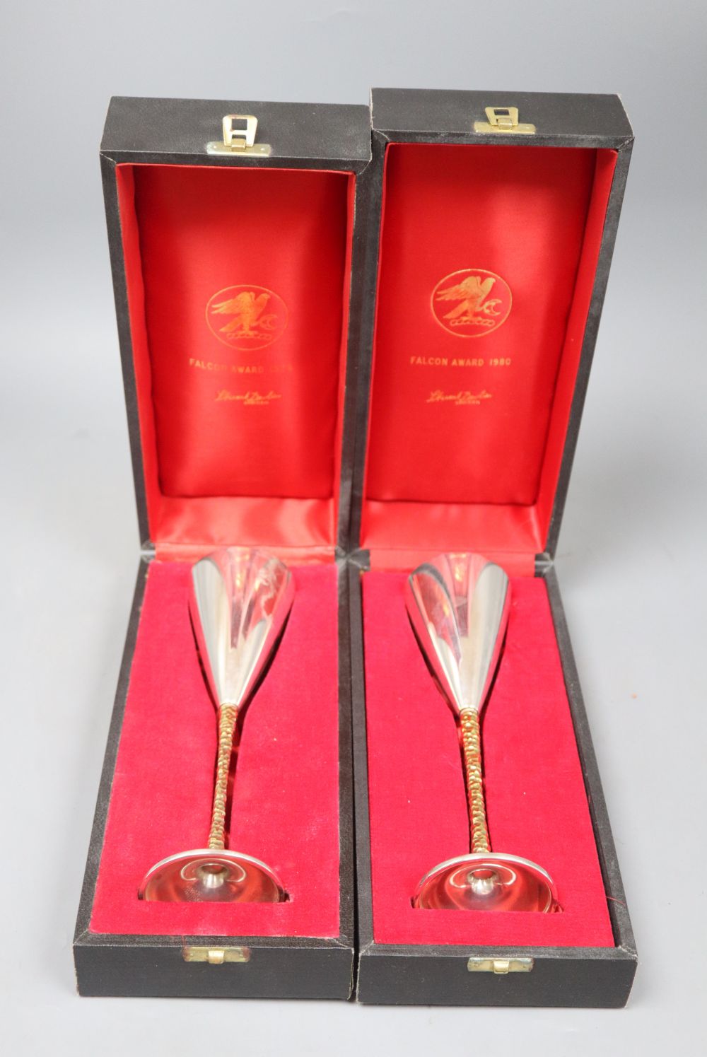 Two cased Stuart Devlin parcel gilt silver champagne flutes, London, 1980, numbered 546 & 191, 22.2cm, gross 12oz.